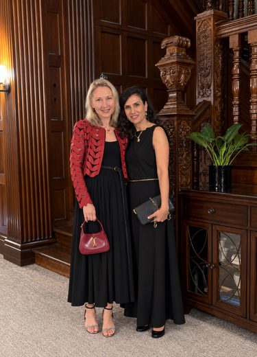 The two of us dressed up for an evening event, standing side by side in a wood-panelled hall.